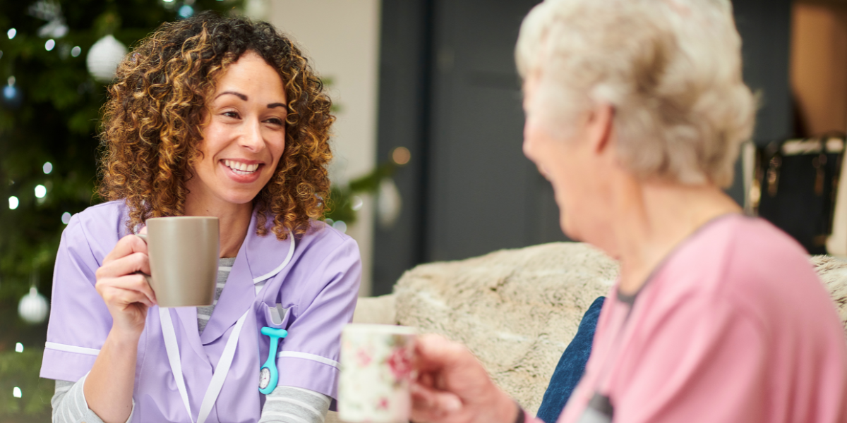 senior woman and her doctor drinking tea together